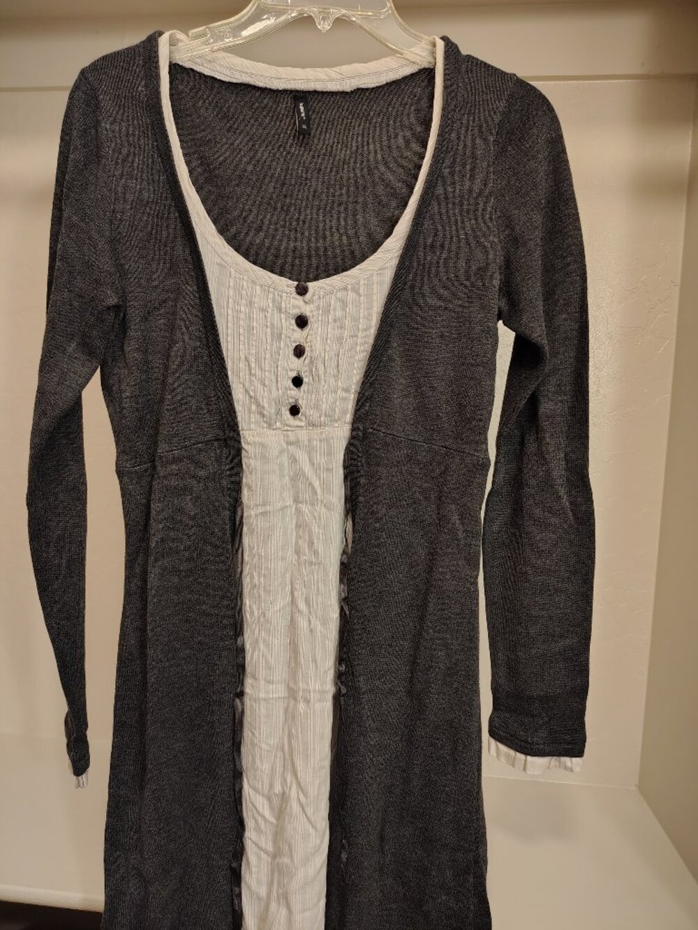 charcoal gray and white layered top featuring a ribbed knit cardigan style